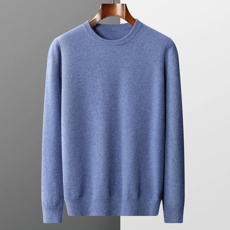 Indulge in the luxurious comfort of this essential men's sweater crafted from 100% merino wool. Boasting an O-neck and knitted long sleeves, this classic piece is adorned in a timeless solid colour, offering a perfect blend o